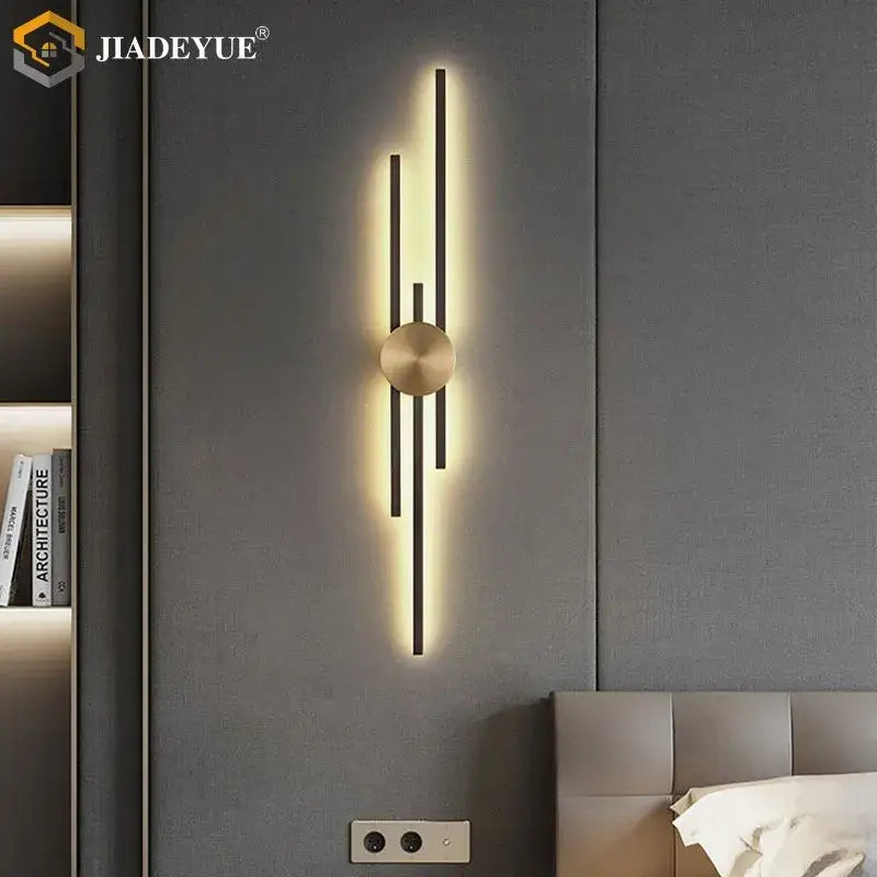 Modern minimalist decorbites led long wall lamp with brushed gold center and black bars emitting warm ambient light