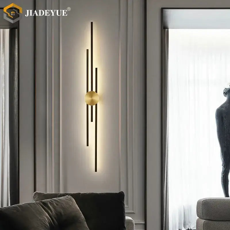 Modern minimalist wall lamp with brushed gold base and black rods designed by jiadeyue decorbites led long wall lamp