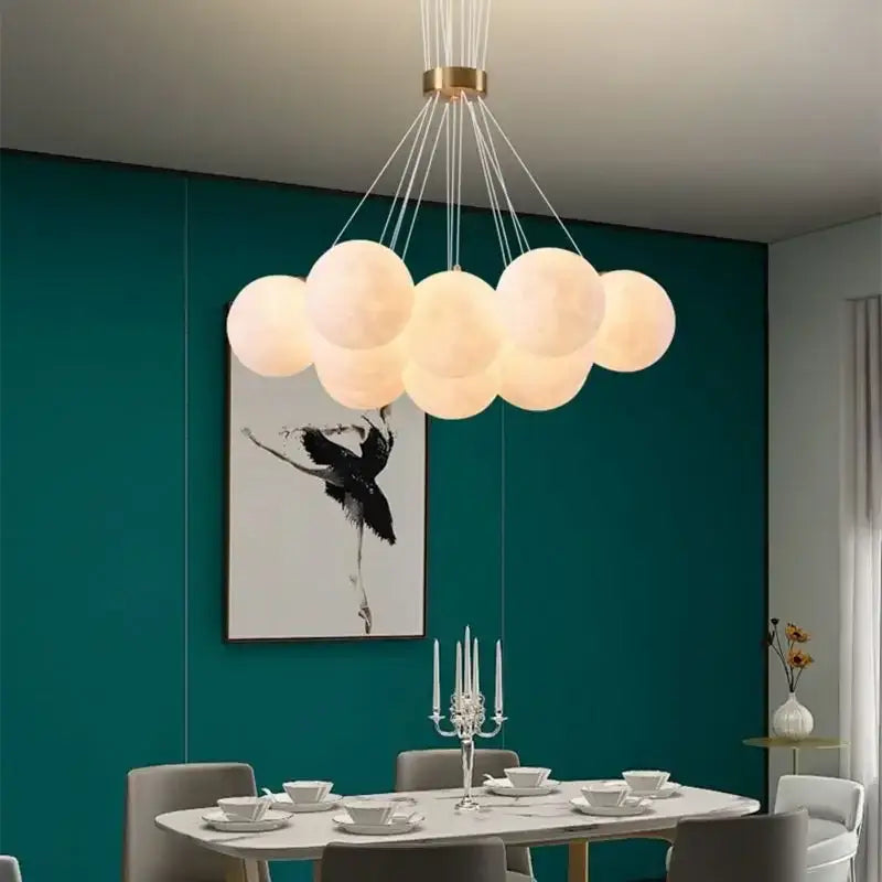 Cloud-shaped decorbites led lunar ball chandelier with off-white bulbs and gold-toned fixture for home decor