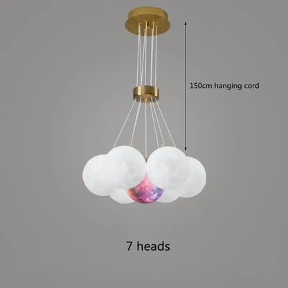 A modern decorbites led lunar ball chandelier with gold metal frame and seven glass orbs including one galaxy orb