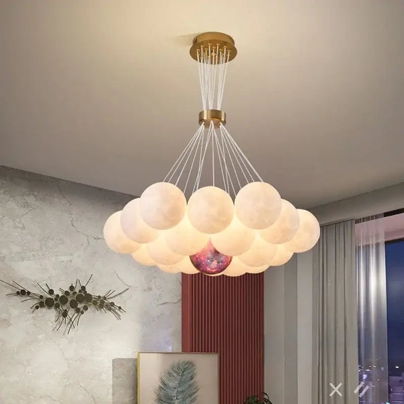 Cloud-shaped decorbites led lunar ball chandelier with frosted white bulbs and a cosmic central bulb in gold fixture