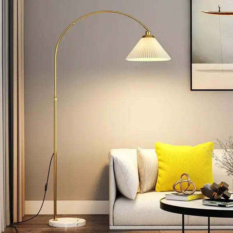 Gold-toned DecorBites LED marble base floor lamp with arched design and white pleated fabric shade for modern living room lighting