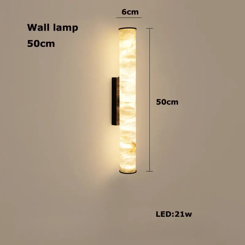 A sleek 50cm tall led marble hanging lamp with a warm amber white alabaster body and black metal bracket