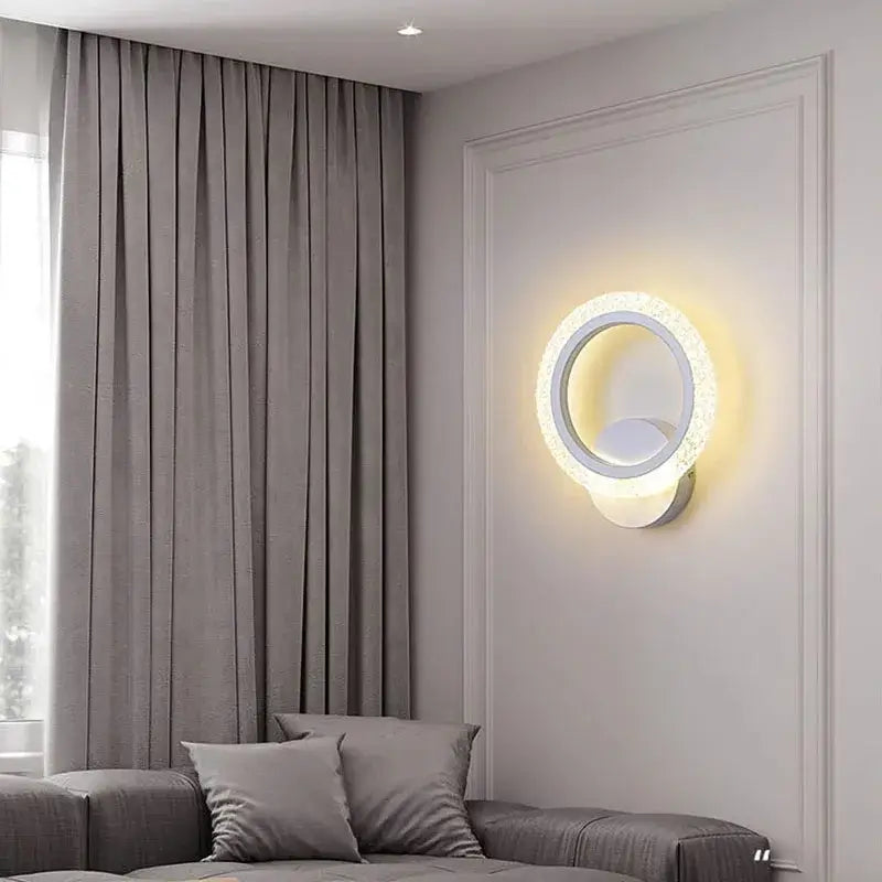 Modern circular decorbites led metal acrylic wall light with glowing inner ring and textured rim emitting warm light
