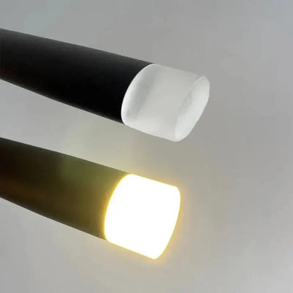 Two cylindrical decorbites led minimalist pendant lamps with black and dark brown bodies emitting cool and warm light