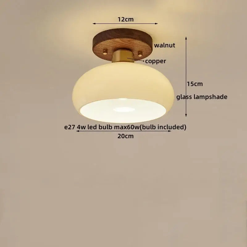 Rounded glass lampshade with warm glow on walnut base and copper hardware in decorbites led modern ceiling light