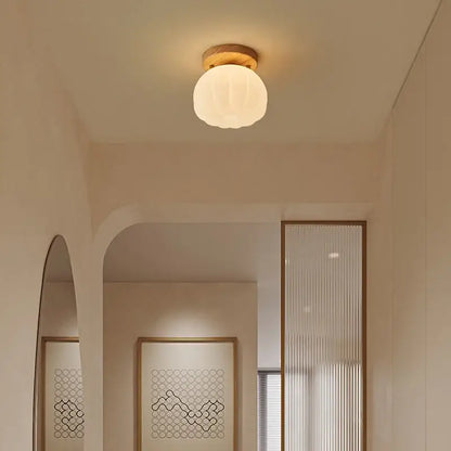 A warm frosted glass globe ceiling light with wooden base decorbites led modern fixture for living room balcony