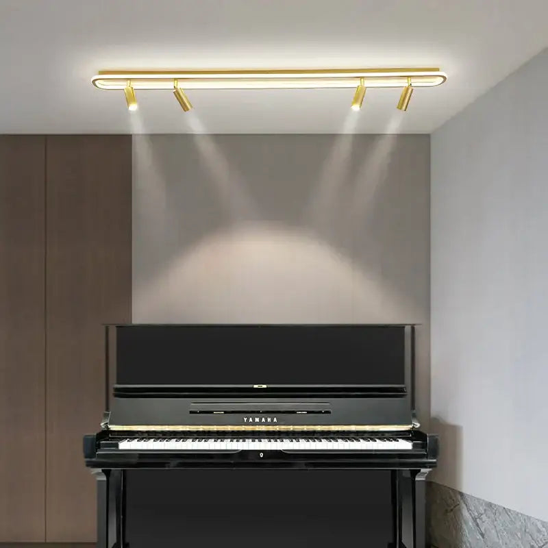 Black yamaha upright piano with glossy finish and gold trimmed keys alongside decorbites led modern chandelier