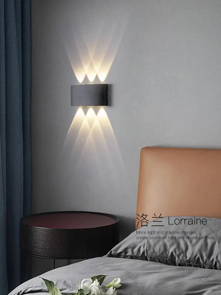 Modern black rectangular decorbites led modern wall lamp with three warm white led lights casting geometric shadows
