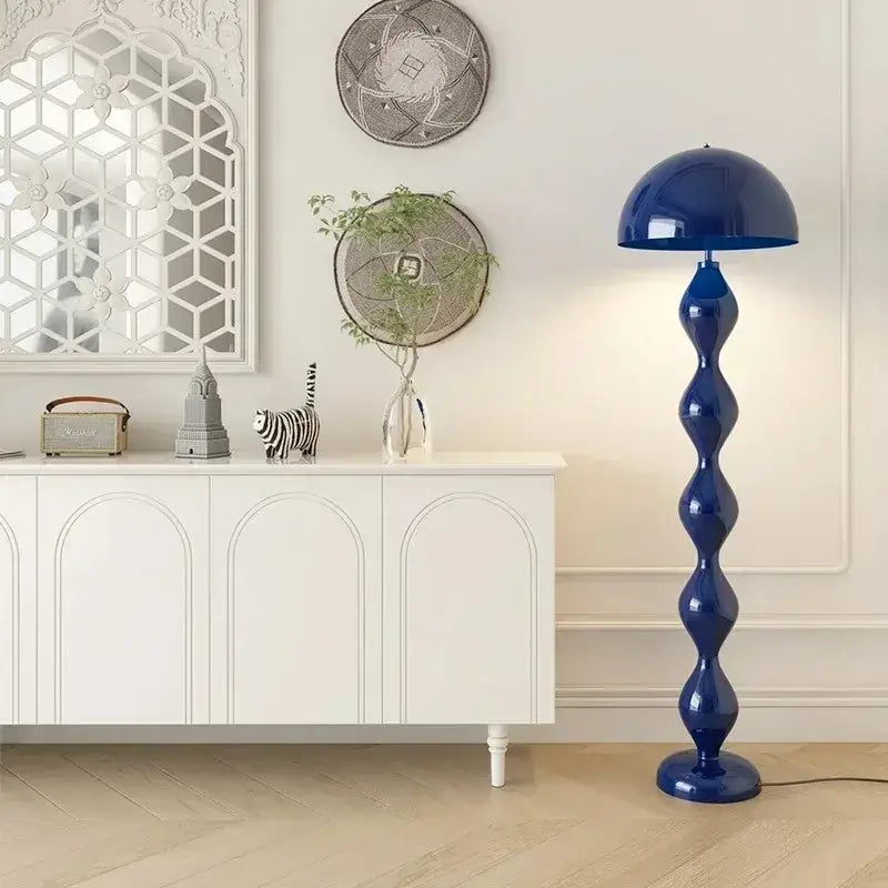 A sleek cobalt blue decorbites led mushroom floor lamp with a glossy dome shade and segmented sculptural base