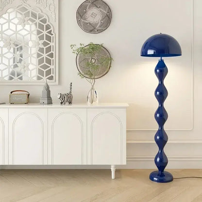 A sleek cobalt blue decorbites led mushroom floor lamp with a glossy dome shade and segmented sculptural base