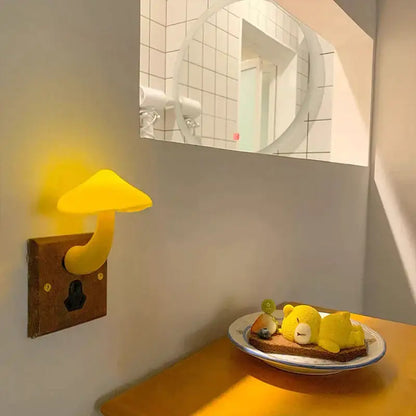 Yellow decorbites led mushroom night light with smooth glossy finish on wooden wall plate with light-controlled sensor