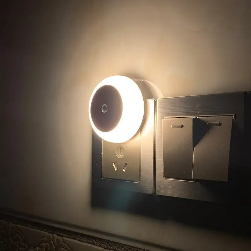 A sleek circular decorbites led night light with warm glow and smart sensor for bedroom hallway use