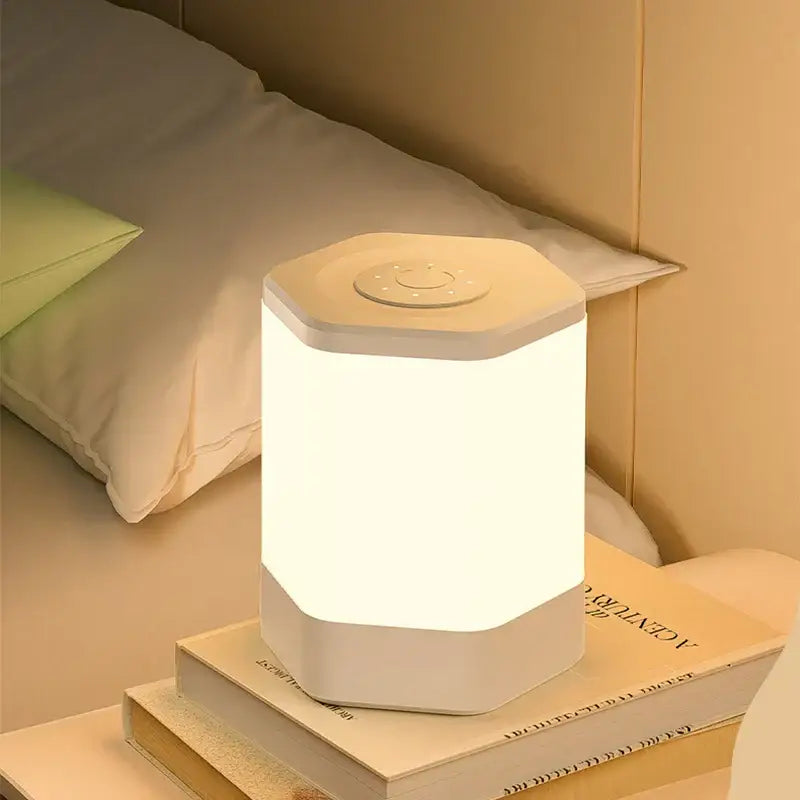 A sleek off-white hexagonal DecorBites led night light with soft glow and touch control for bedside table use