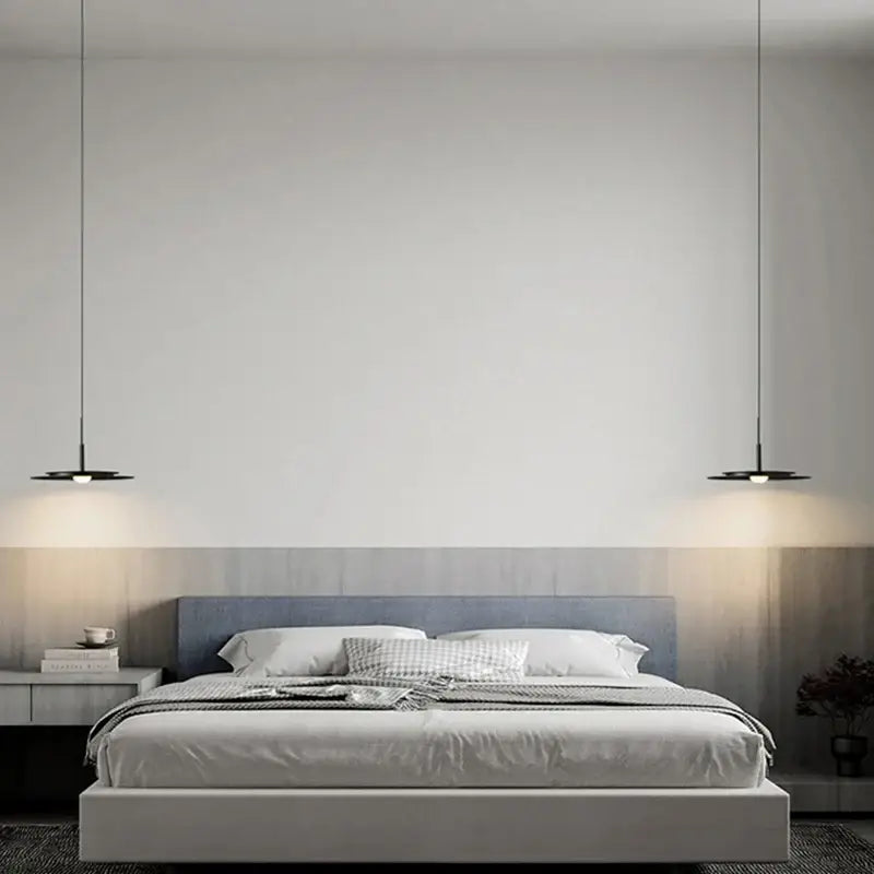 Modern minimalist bed with gray upholstered headboard and white bedding under decorbites led nordic flying saucer chandelier
