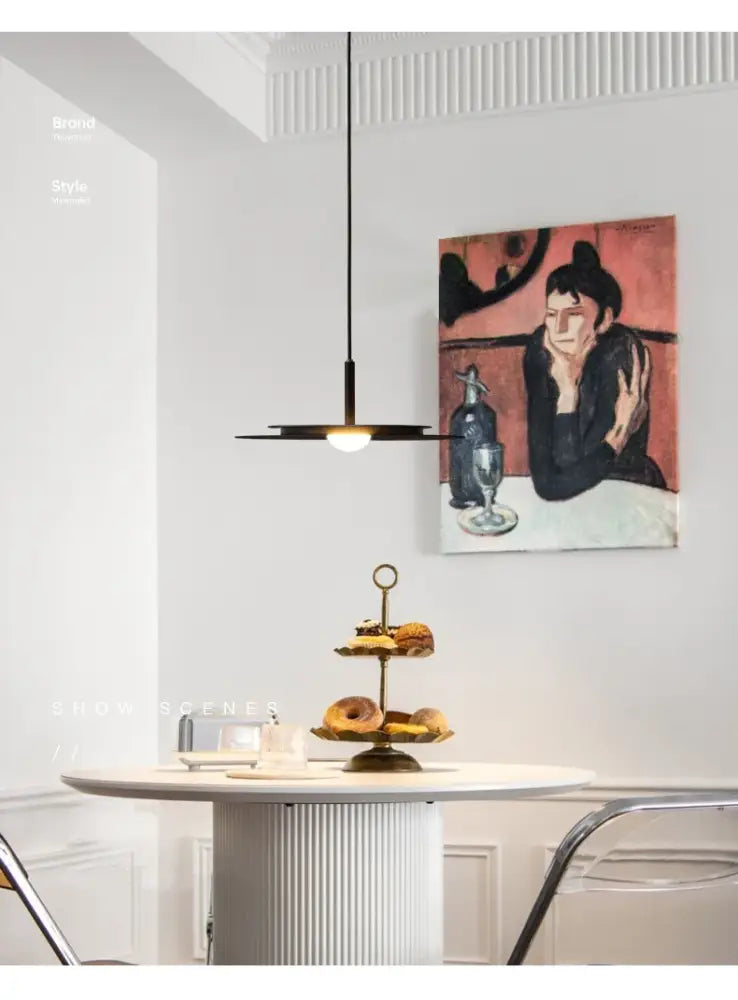 A sleek black decorbites led nordic flying saucer chandelier with modern minimalist design hanging above a table