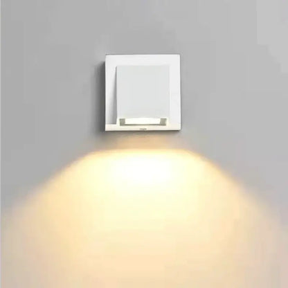 Modern white square decorbites led outdoor wall light with sleek minimalist design emitting warm light for porch use