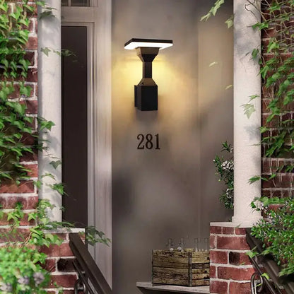 Black DecorBites™ modern wall lamp with flat-panel design and warm illumination for outdoor wall use