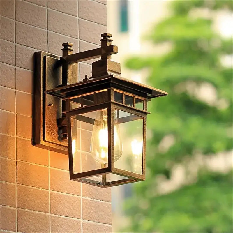 Antique bronze-finished decorbites led outdoor wall lamp with clear glass panels and visible filament bulb for outdoor use