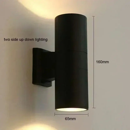 Black cylindrical DecorBites™ outdoor wall lamp with dual up-down LED lighting for porch waterproof use