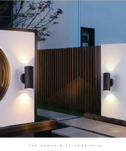 Black cylindrical DecorBites™ LED outdoor wall lamp with sleek modern design and waterproof feature for porch lighting
