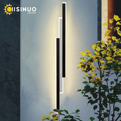 Modern minimalist decorbites led outdoor wall lantern with sleek black and white bars emits warm ambient glow