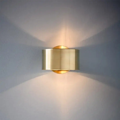 Brass cylindrical wall light with sleek modern design casting warm light for decorbites led outdoor wall use