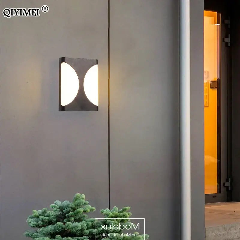 Modern black decorbites led outdoor wall sconce with two illuminated oval panels for courtyard patio front door use