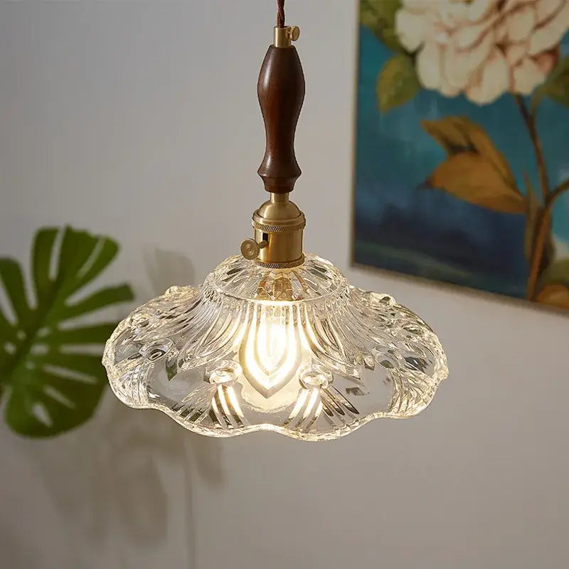 Clear intricately cut glass pendant lamp with brass fixture and dark wood pull chain by decorbites led pendant