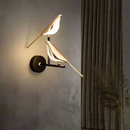 Gold-toned bird-shaped led pendant lamp with sleek minimalist design and warm glow for bedroom interior decor