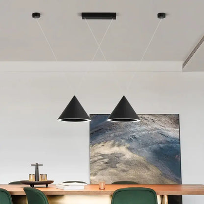 Two sleek black conical decorbites led pendant lights hang by thin white cords as minimalist led pendant lamps for kitchen island