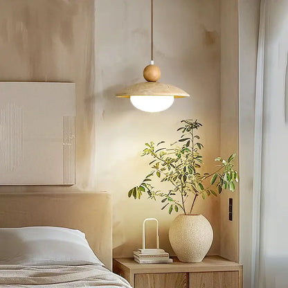 A warm-toned decorbites led pendant lamp with a wooden spherical top and beige travertine disc shade