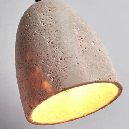 Decorbites led pendant lamp in yellow travertine features a textured light gray concrete pendant lamp with warm interior glow