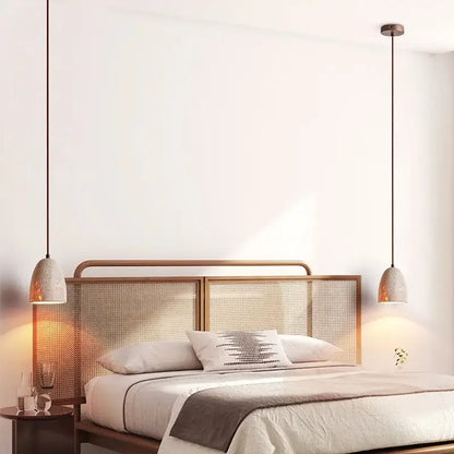 Two decorbites led pendant lamps with textured off-white ceramic shades and dark metal cords in yellow travertine style