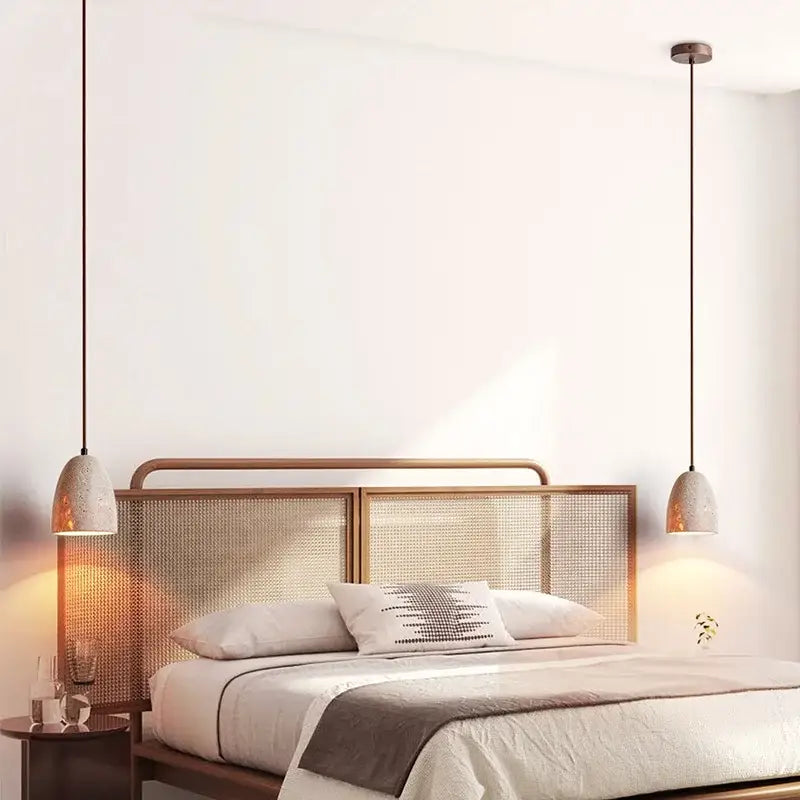 Two decorbites led pendant lamps with textured off-white ceramic shades and dark metal cords in yellow travertine style