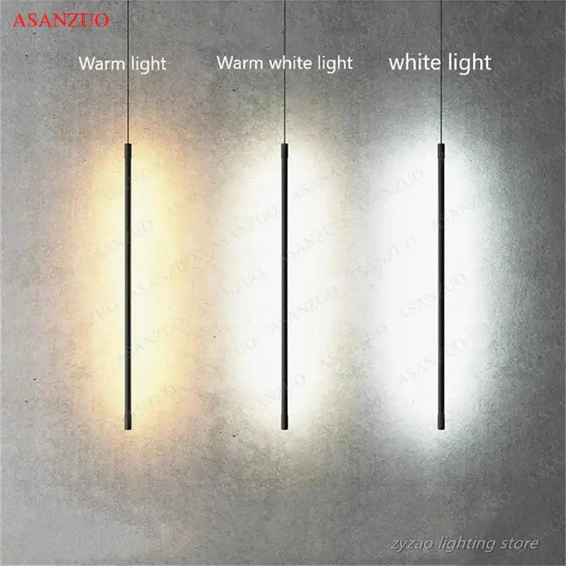 Three slim black pendant lights from decorbites™ with adjustable line strip emit warm, warm white, and white light