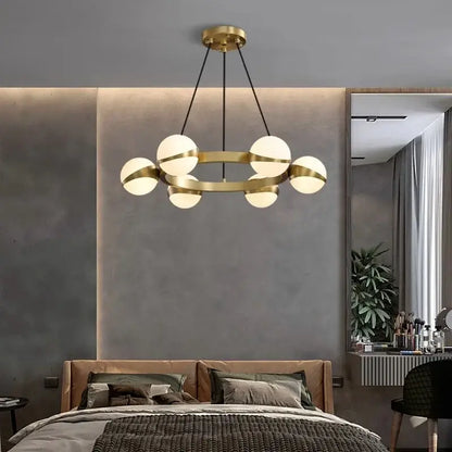 Modern brass DecorBites LED pendant light chandelier with six frosted glass globe lights for indoor lighting decor