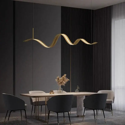 Golden wave-shaped DecorBites LED pendant light with sleek metallic finish hangs above dining table for modern decor