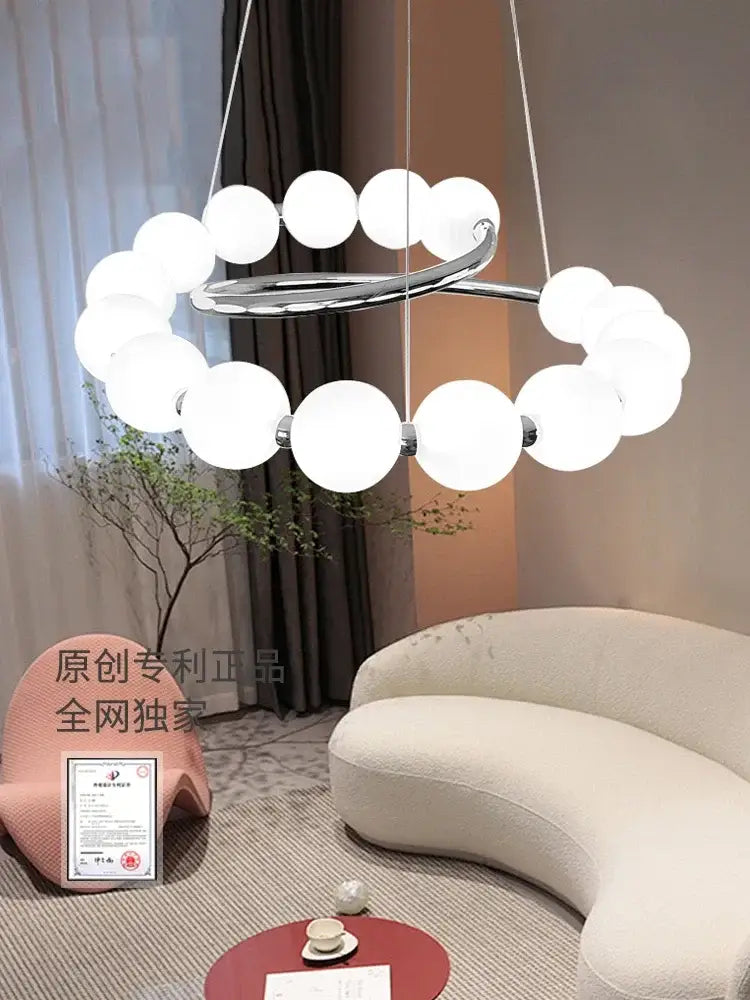 Modern chrome-finished decorbites pendant light chandeliers with circular frame and frosted white spherical bulbs for living room
