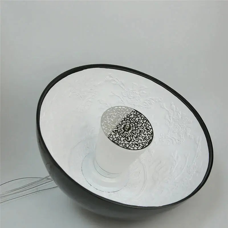 A sleek black and white ceramic bowl with embossed floral pattern featured alongside decorbites led pendant light