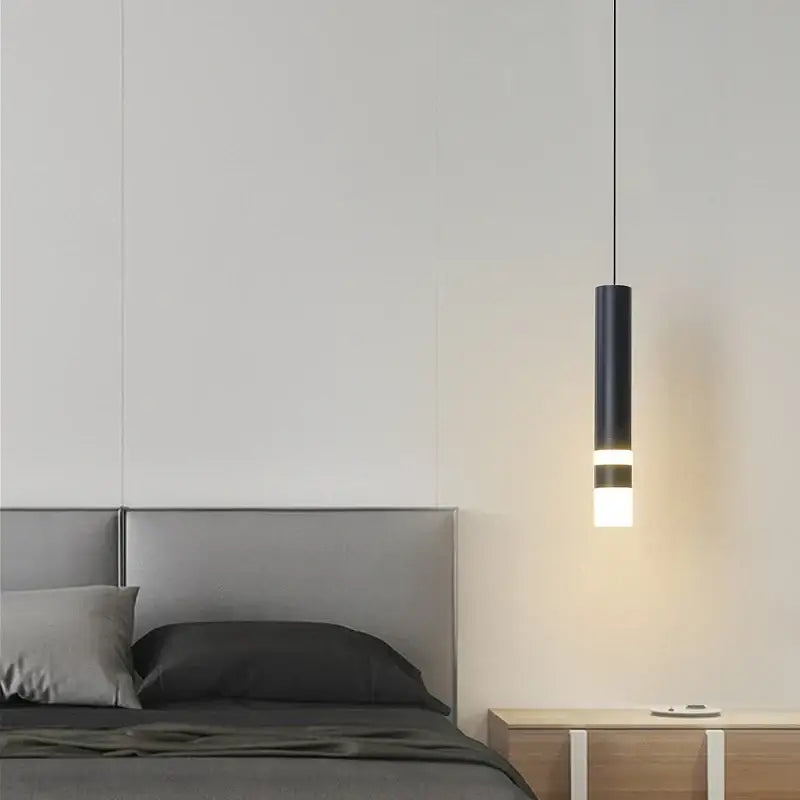 Black cylindrical DecorBites led pendant light with glowing white illuminated band for modern indoor decoration