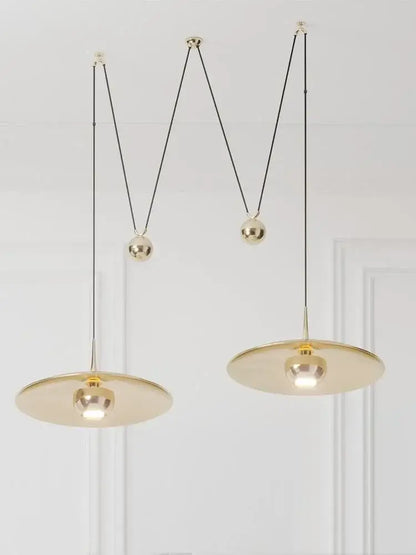 Gold-toned DecorBites™ LED pendant lighting with sleek circular shades and adjustable black cords for bedroom and dining room