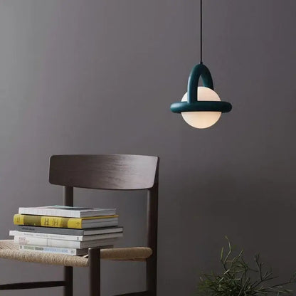 Teal decorbites led pendant light with arched metal frame and frosted glass globe for dining room and kitchen use
