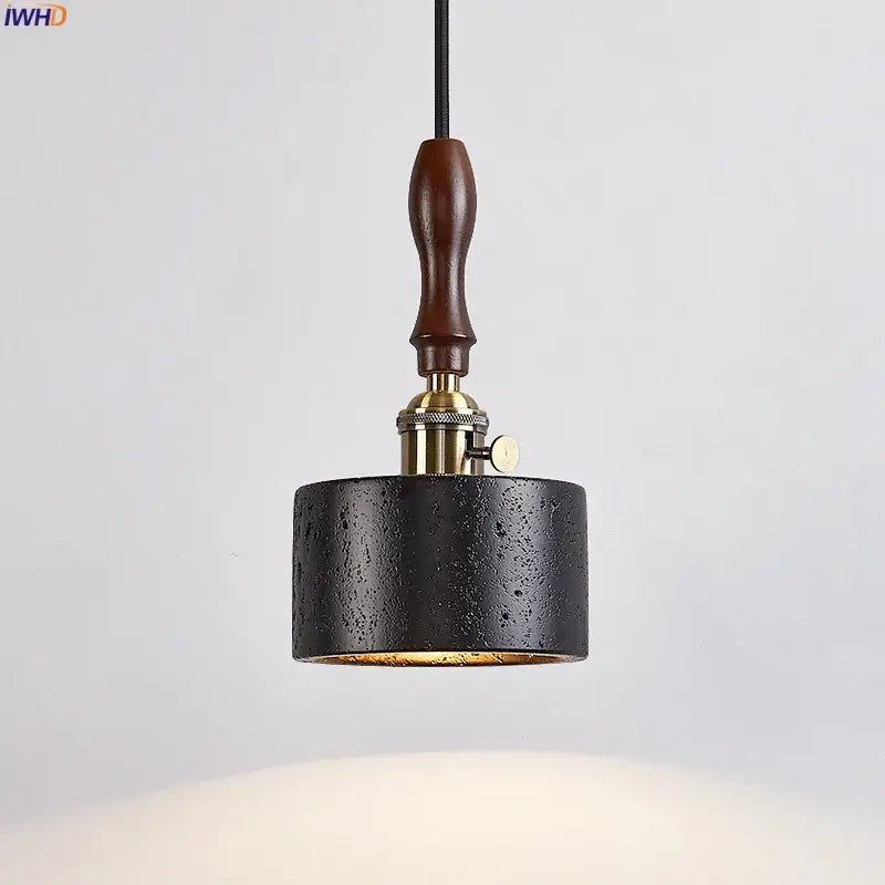 Black textured cylindrical pendant light with brass fixture and dark wood handle by decorbites led pendant light black travertine
