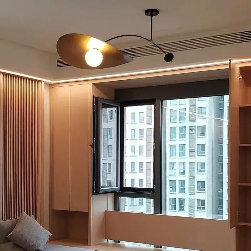 Modern gold-toned DecorBites LED pendant lights with a sleek curved arm and oval shade for minimalist home decor