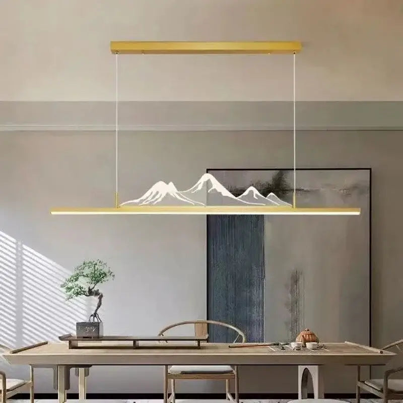 Gold-toned decorbites led pendant light with minimalist mountain silhouette design for modern home lighting