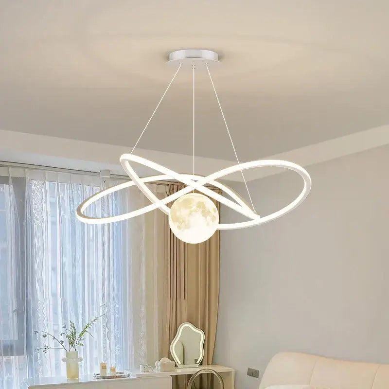 Modern white led pendant lights by decorbites featuring intertwined circular rings and a glowing moon-shaped pendant