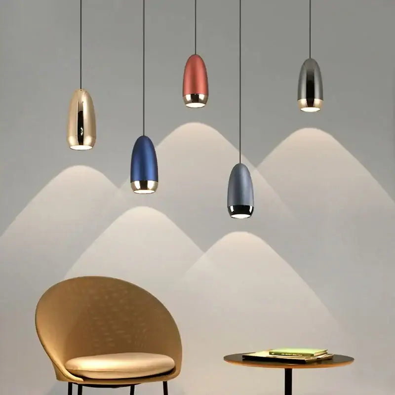 Five decorbites led pendant lights with sleek teardrop shapes in gold copper blue and silver for modern interiors