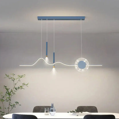Modern blue and white decorbites led pendant lights featuring sleek cylindrical fixtures and illuminated circular element for dining