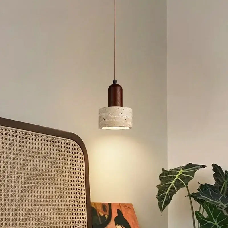 A minimalist decorbites led pendant light with dark brown wooden top and cylindrical concrete shade for modern interiors
